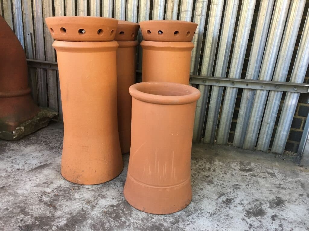 Terracotta chimney pots ready for fitting