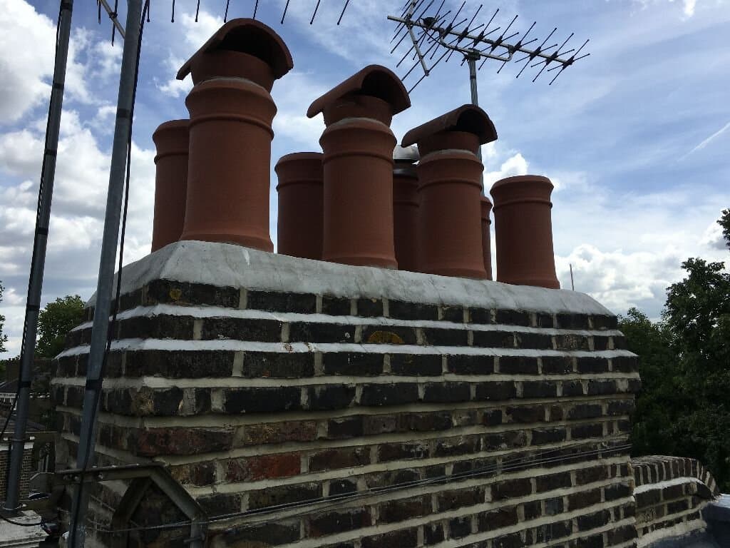 Multi-pot chimney stack with fitted cowls