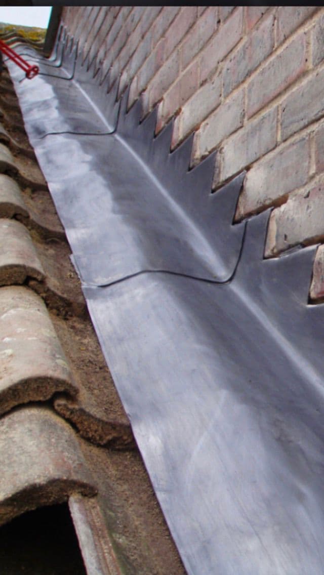 Lead flashing work installed around a roof junction