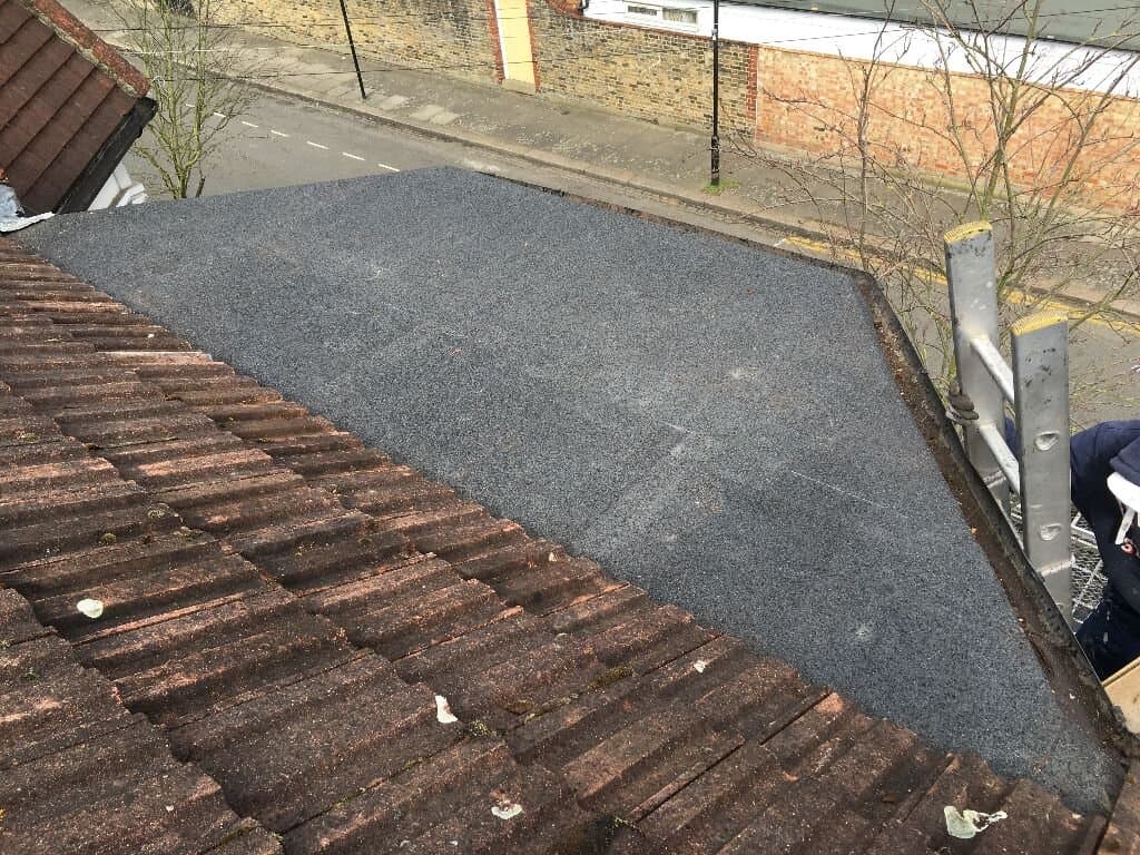 Flat roof edge detail near pitched tile sections