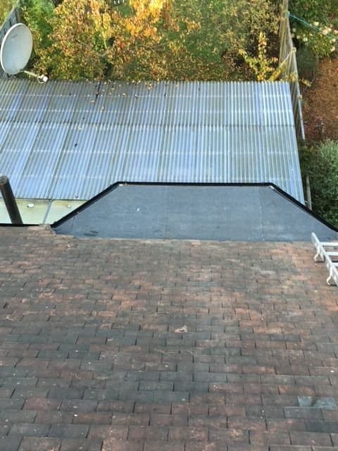 Flat roof repair with new felt finish and perimeter detailing