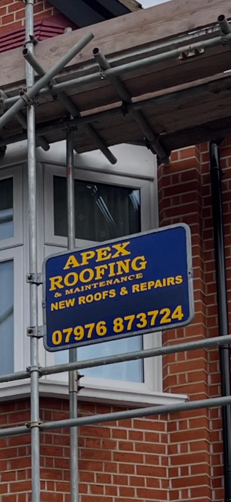 Apex Roofing sign displayed on-site during roof works